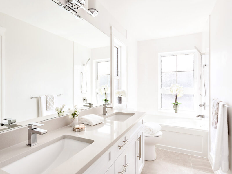 Quietly luxurious bathroom, elegant en-suite bathroom, soothing grey accents, large walk-in modern shower, sleek porcelain tiles, Maxine Whitehead design