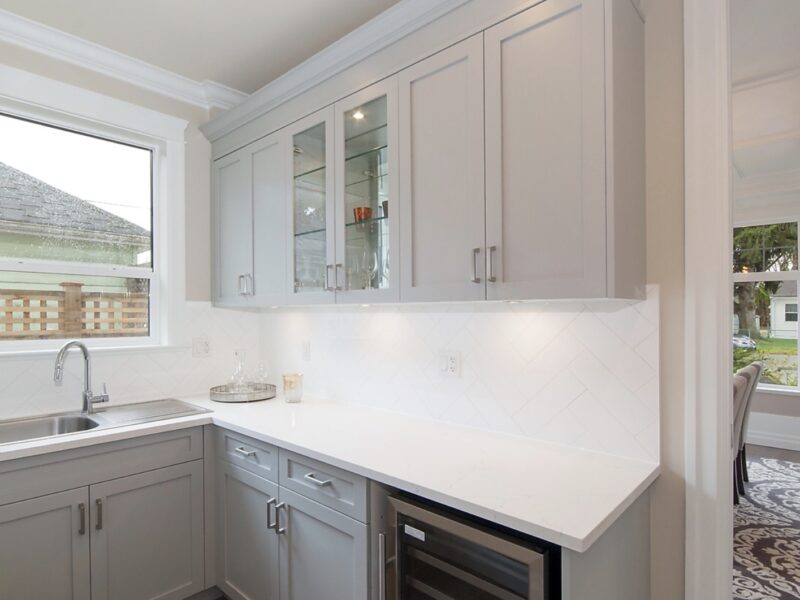 Wine cooler in butler's pantry, polished quartz countertops and backsplash, convenient pantry storage, Maxine Whitehead design