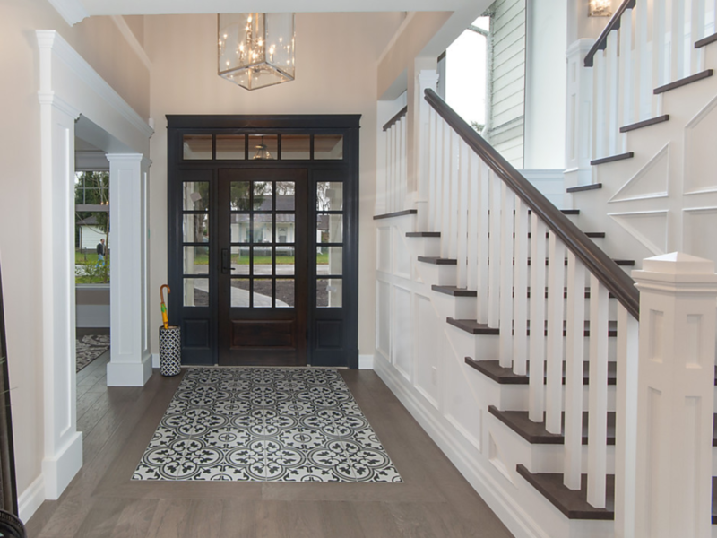 Welcoming entrance and elegant staircase, double-story staircase window adds welcome light, In-lay floor tile dresses up the entrance, door paint Benjamin Moore Wrought Iron, Maxine Whitehead design