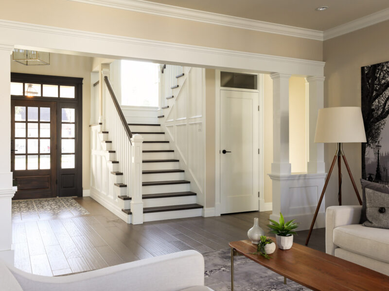 Welcoming entrance and elegant staircase, double-story staircase window adds welcome light, In-lay floor tile dresses up the entrance, door paint Benjamin Moore Wrought Iron, Maxine Whitehead design