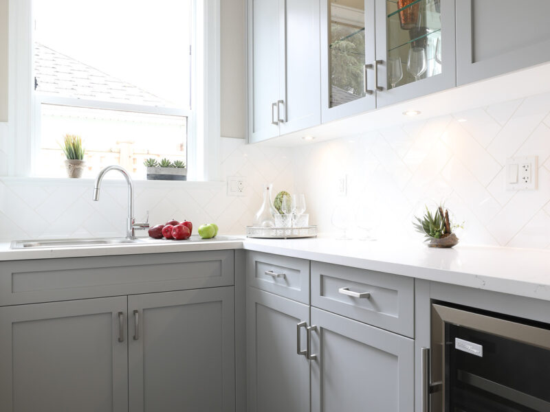 Wine cooler in butler's pantry, polished quartz countertops and backsplash, convenient pantry storage, Maxine Whitehead design