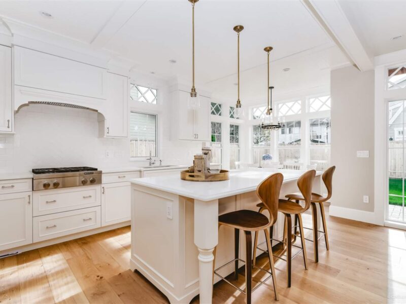 bespoke kitchen design, shaker style kitchen cabinets, timeless white kitchen style, classic white kitchen, spacious kitchen island, polished quartz countertops, statement lighting, crown molding, iconic mid-century counter stool, Maxine Whitehead Design