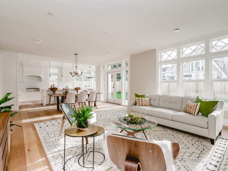 Classic interior design meets modern living room, open plan living, classic mix with natural materials, soft patterned rug underfoot, french doors lead to a spacious back yard, wide plank wood flooring, historic charm and unique character, Maxine Whitehead design