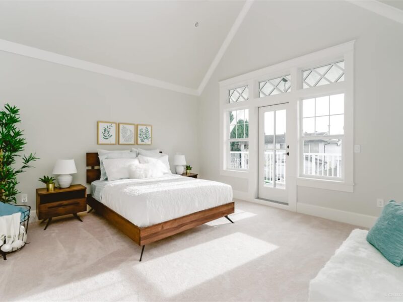 primary bedroom designed for comfort and relaxation, spacious bedroom oasis, washed in white, vaulted bedroom ceiling, light-flooded bedroom, soft carpeting underfoot, Maxine Whitehead design