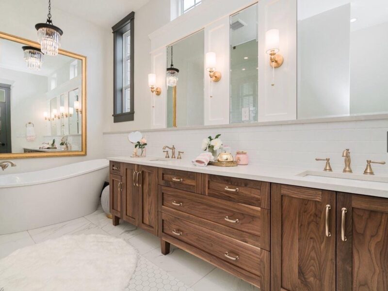 bespoke bathroom design, walnut wood vanity cabinet, double sinks, polished quartz countertop, elegant wall sconces, soaker tub, freestanding tub, hexagon tile, Maxine Whitehead Design