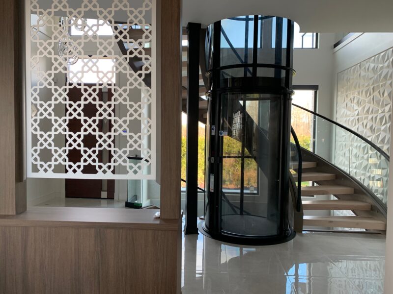 sweeping curved staircase, contemporary style, river front property, glass elevator, modern foyer, Maxine Whitehead design