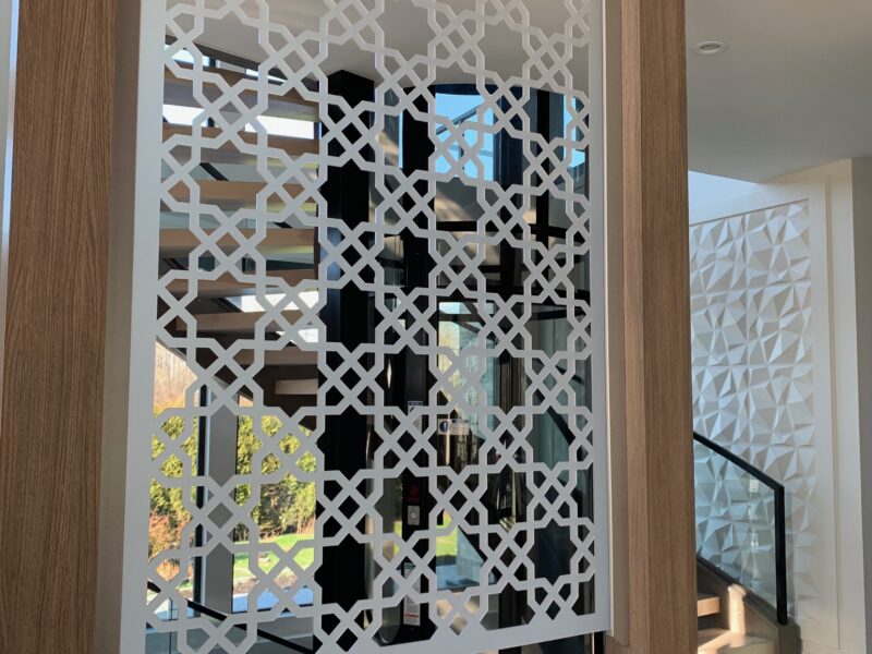 custom room divider, star pattern, pointed star, geometric design, sweeping curved staircase, contemporary style, river front property, glass elevator, modern foyer, Maxine Whitehead design