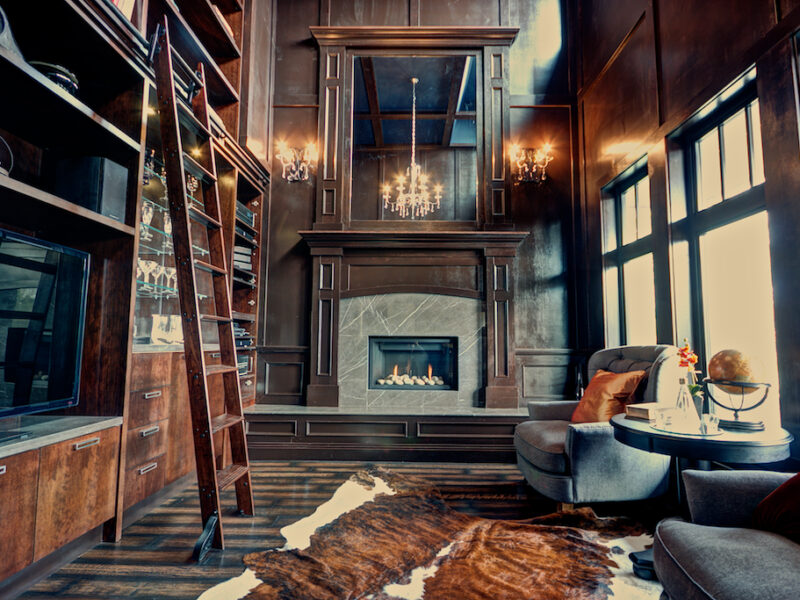 wood panel library, library ladder, grand chandelier, library books, grand fireplace, wing back chairs, Maxine Whitehead design