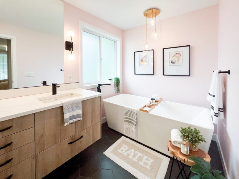 bespoke bathroom design, white oak wood vanity cabinet, double sinks, polished quartz countertop, elegant wall sconces, soaker tub, freestanding tub, hexagon tile, Maxine Whitehead Design