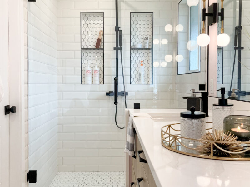 bespoke bathroom design, white oak wood vanity cabinet, double sinks, polished quartz countertop, elegant wall sconces, soaker tub, freestanding tub, hexagon tile, Maxine Whitehead Design